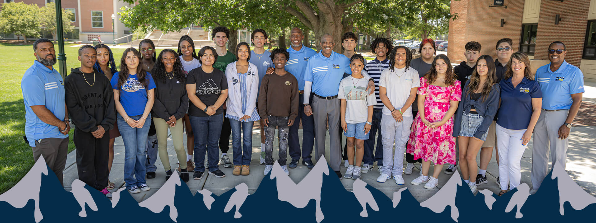 A group of PBLA students stand and pose for a picture